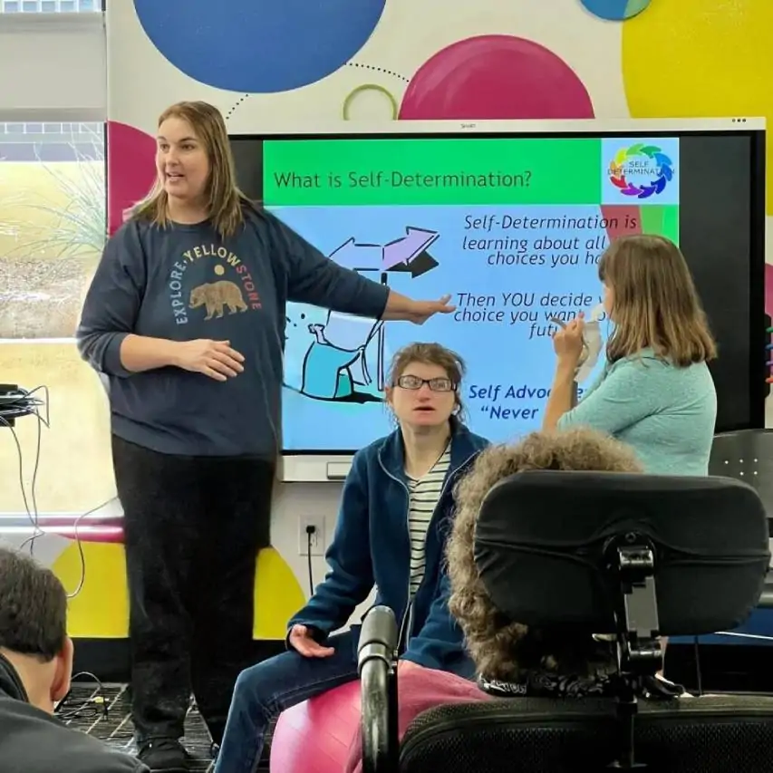 A Cortney's Place volunteer member teaching a self-determination class to support communication and social skills for adults with IDD