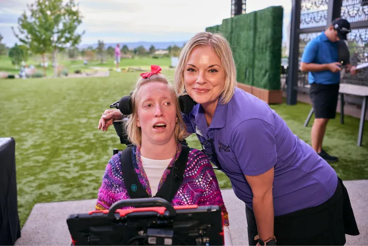 A Cortney's Place staff member with a participant in the school to adult day programs transition community event.
